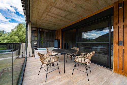 a patio with a table and chairs on a balcony at Merlrose Apartments in Sankt Kanzian