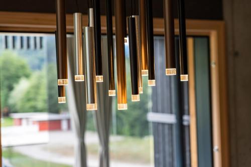 a group of chandeliers hanging from a window at Merlrose Apartments in Sankt Kanzian