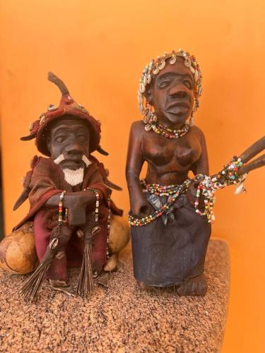 two statues of two people sitting next to each other at Tropic Garden Hotel in Bathurst