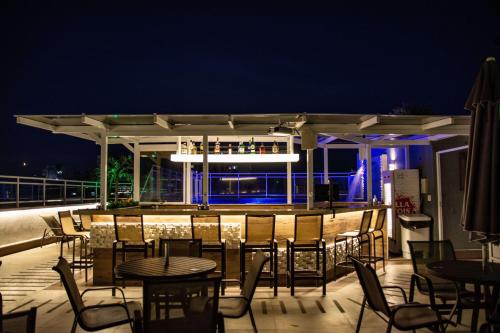 a bar on the roof of a building at night at Casa Nova Hotel in Rio de Janeiro