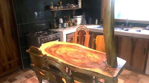 a wooden table in a kitchen with a stove at Diosa de la Montaña in Jama