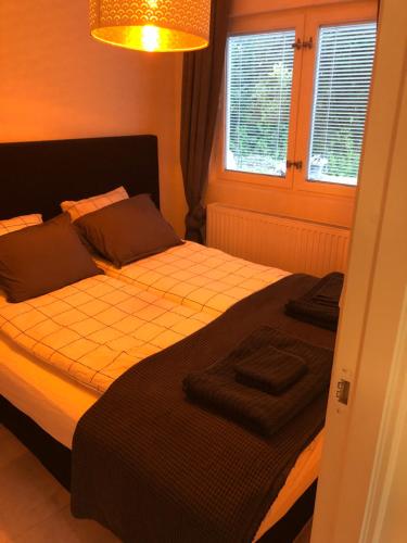 a bedroom with a bed and a lamp at A Beautiful one bedroom apartment in Stockholm