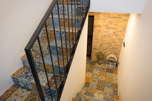 a staircase with stained glass windows and a tile floor at Sklep Mozajka in Velké Bílovice