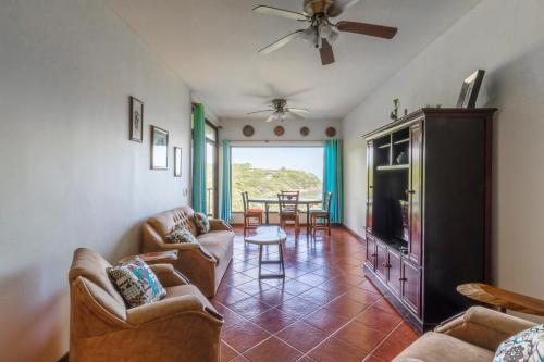a living room with couches and a flat screen tv at Ocotal Beach Front Condo #38 in Ocotal