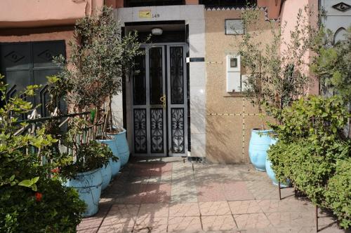 a front door of a house with potted plants at Dar Benyounes in Benguerir