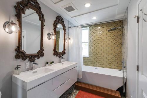 a bathroom with a sink and a tub and a mirror at Trendy Fairmount Gem-5 star Location, Roof Deck, PARKING, GR8 for FAMILIES in Philadelphia