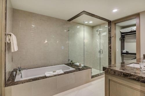 a bathroom with a tub and a glass shower at Resort Room Hotel Room in Park City