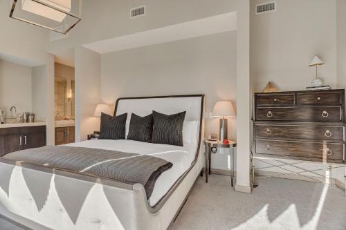 a white bedroom with a large bed and a dresser at Resort Room Hotel Room in Park City