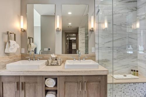 a bathroom with two sinks and a glass shower at Resort Room Hotel Room in Park City