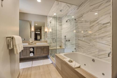 a large bathroom with a tub and a sink at Resort Room Hotel Room in Park City