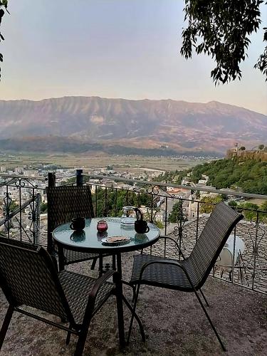 a table and two chairs on a patio with a view at Panoramic Vlachos in Gjirokastër