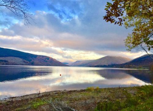 a view of a lake with mountains in the background at Seal Point Cabin - Luxury Glamping in Cairndow