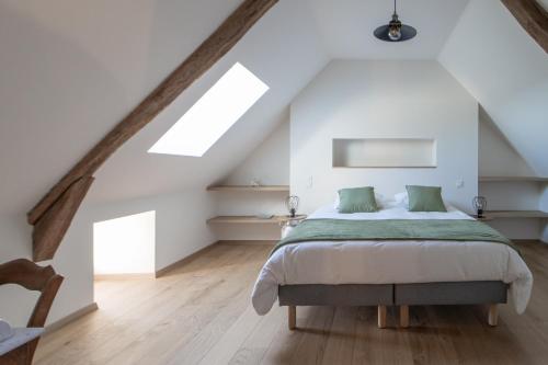 a bedroom with a large bed in a attic at La Maison de Louise in Colombiès