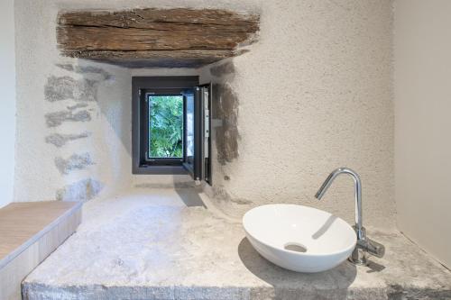 a bathroom with a sink and a window at La Maison de Louise in Colombiès
