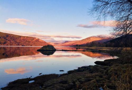 a view of a lake with mountains in the background at Seal Point Cabin - Luxury Glamping in Cairndow