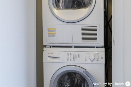 a microwave sitting on top of a washing machine at 304 Newbury Street by Thatch in Boston