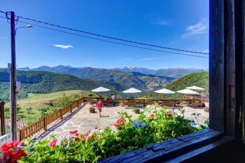 a view from a window of a patio with flowers and umbrellas at Casa Lamadrid in Cahecho