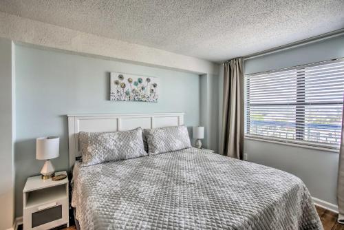 a bedroom with a bed and a window at North Myrtle Beach Oceanfront Condo with Pool! in Myrtle Beach