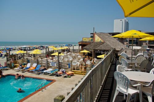 a view of a pool with people in chairs and umbrellas at Sands Ocean Club in Myrtle Beach