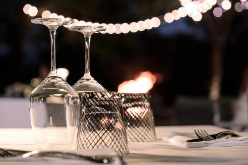 a couple of wine glasses sitting on top of a table at Claudio Rooms in Fabbrico