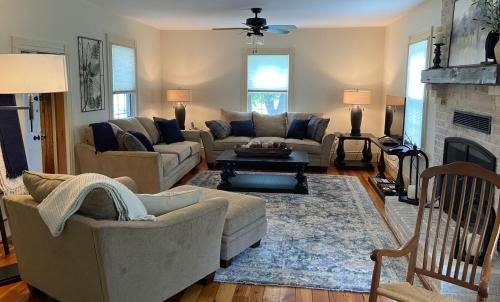 a living room with two couches and a fireplace at Graves Mountain Farm & Lodges in Syria