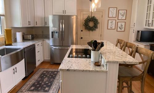 a kitchen with white cabinets and a stainless steel refrigerator at Graves Mountain Farm & Lodges in Syria