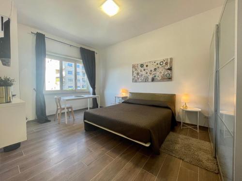 a bedroom with a bed and a desk and a window at Dreamsrome Lux in Rome