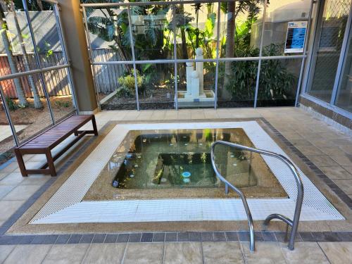 a hot tub in the middle of a building with a bench at 40 William Street Apartments in Port Macquarie