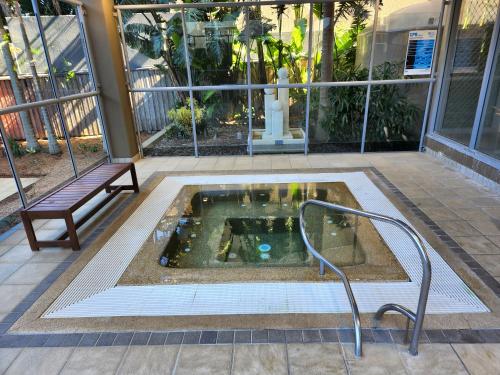 a hot tub in the middle of a building with a bench at 40 William Street Apartments in Port Macquarie
