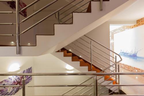 a staircase with stainless steel railings in a house at Nawigator SPA in Rewal