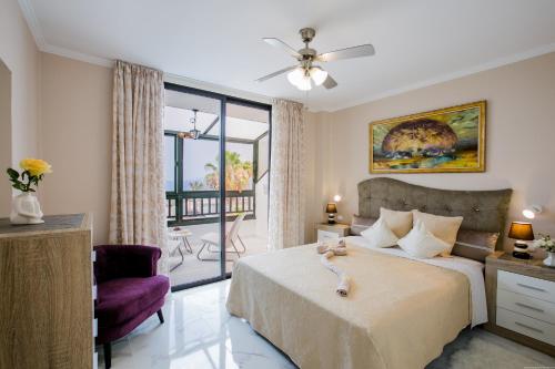 a bedroom with a bed with a ceiling fan at LUX Parque Santiago2 Las Americas First Line in Playa de las Americas