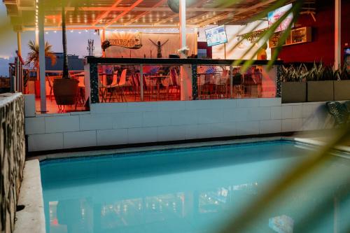 a swimming pool with tables and chairs in a restaurant at Hotel Barrancabermeja Plaza in Barrancabermeja