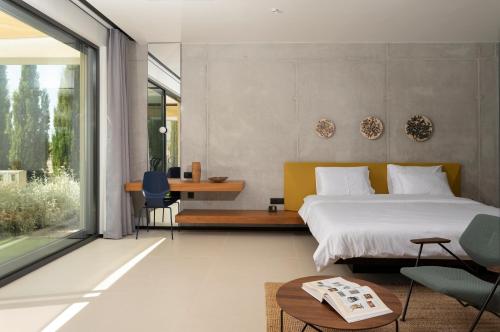 a bedroom with a bed and a table and chairs at Villa Albina & Domenica in Zadar