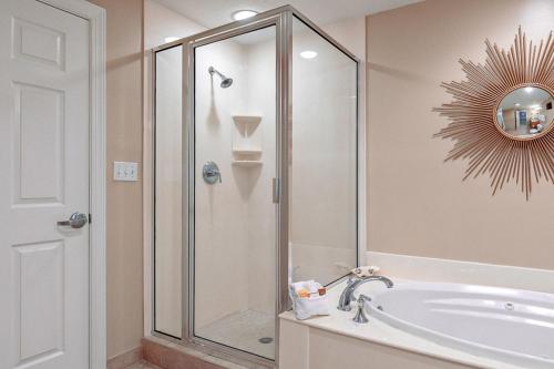 uma casa de banho com um chuveiro e um lavatório branco em Escapes! To The Shores #204 em Orange Beach