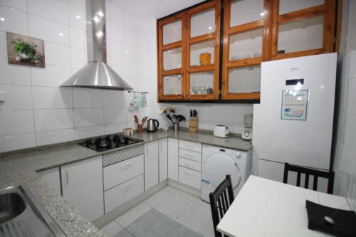 a kitchen with a refrigerator and a stove top oven at Rooms Aribau in Barcelona