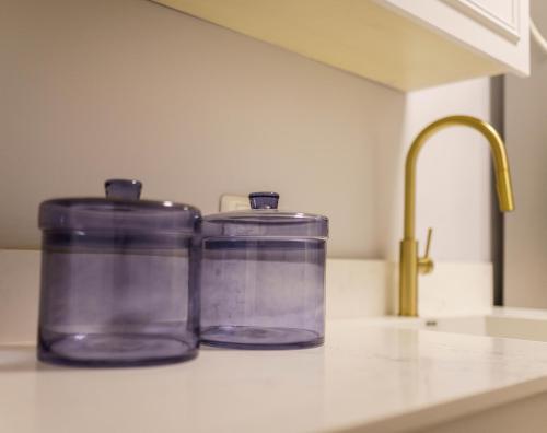 two containers sitting on a kitchen counter next to a sink at שירת צפת in Safed