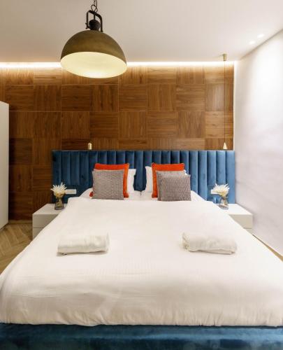 a bedroom with a large white bed with a blue headboard at שירת צפת in Safed