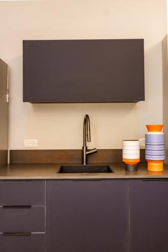 a kitchen with a sink and a counter with plates at שירת צפת in Safed