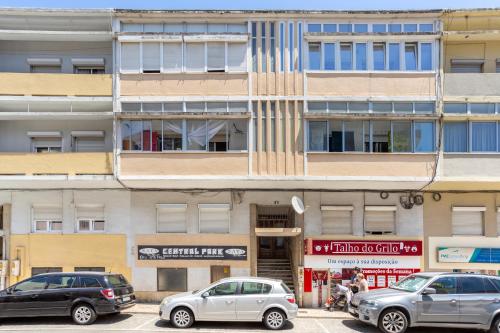 a building with cars parked in front of it at Isabel Dream II, 300m from the train in Algueirão - Mem Martins