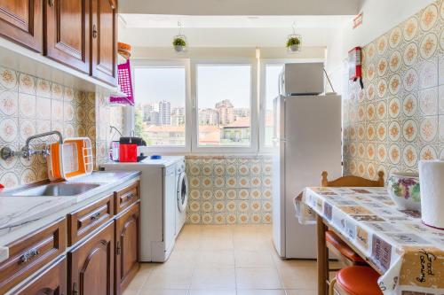 een keuken met een wastafel en een koelkast bij Isabel Dream II in Algueirão