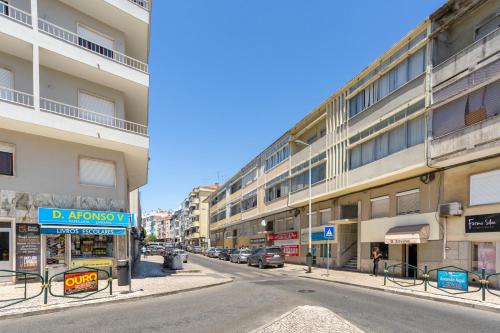 a city street with cars parked in front of buildings at Isabel Dream II, 300m from the train in Algueirão - Mem Martins