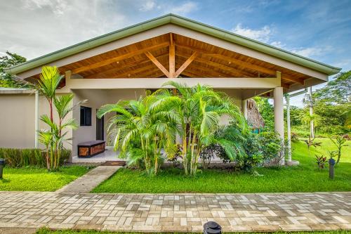a house with a large wooden roof at Hidden Palms in Nosara