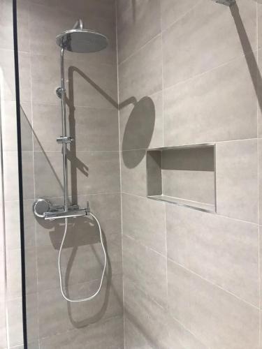 a shower with a heart on the wall in a bathroom at Costa House in Nazaré