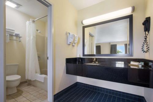 a bathroom with a sink and a mirror and a toilet at Best Western Parkside Inn in Frankfort