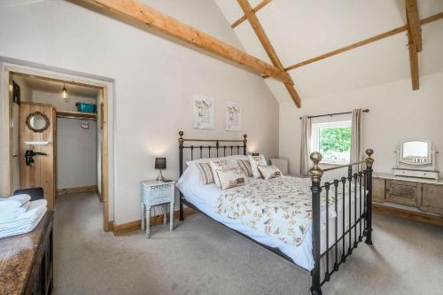 a bedroom with a bed and a window at Warbrook in Sutcombe