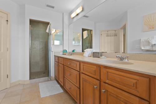a bathroom with a double sink and a shower at Bradenton Beach Club #13 in Bradenton Beach
