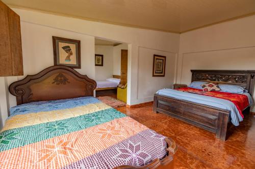 a bedroom with two beds in a room at Alojamiento Rural Finca El Rubí - Eje Cafetero in Quimbaya
