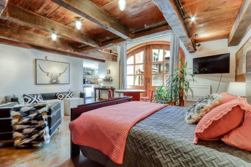 a bedroom with a large bed and a living room at Pine Street Loft in Sisters