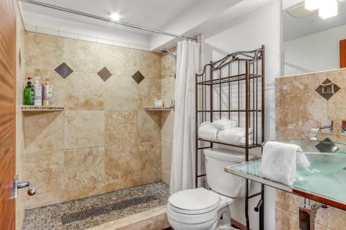 a bathroom with a toilet and a shower at Pine Street Loft in Sisters