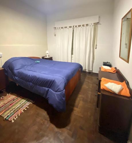 a bedroom with a large blue bed in a room at Casa de Beto in San Pedro